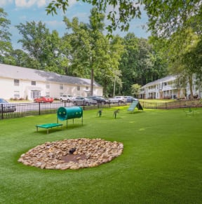 a yard with green grass and trees and a dog park at Lake Johnson Mews Apartments, PRG Real Estate Management, Raleigh, 27606