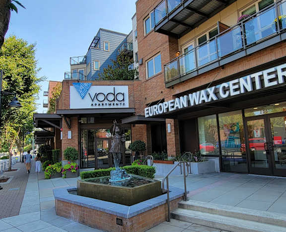 a large brick building with a sign that reads vodafone european wax center