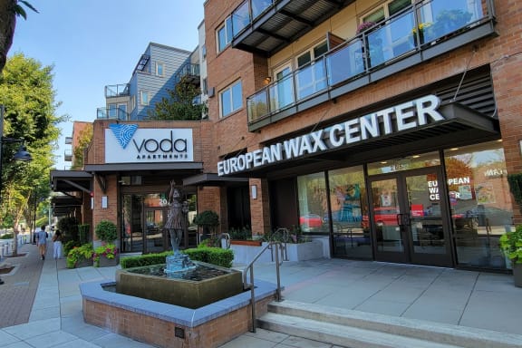 a large brick building with a sign that reads vodafone european wax center