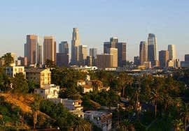a view of a city skyline with trees and buildings