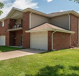 a garage door in front of a brick house
