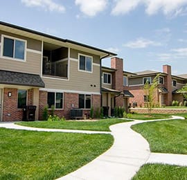 a sidewalk in front of a row of villas