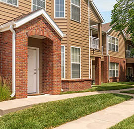 a row of brick houses next to a sidewalk