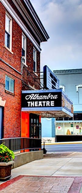 a theater sign on the side of a brick building