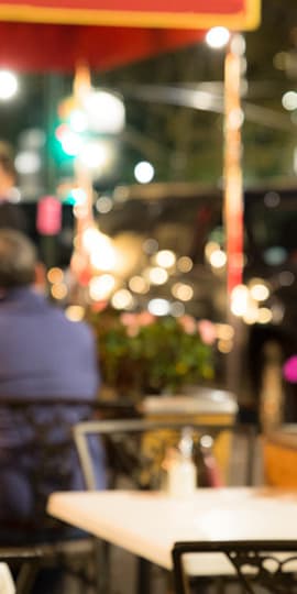 an empty restaurant with tables and chairs at night