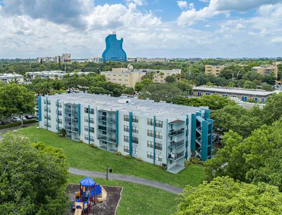 an aerial view of a building with a large blue object in the background at Club at Emerald Waters, Hollywood
