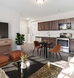 a living room with a couch and a table and a kitchen