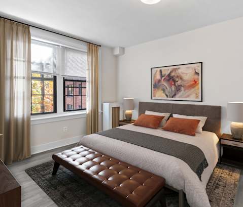 a bedroom with a bed and two windows