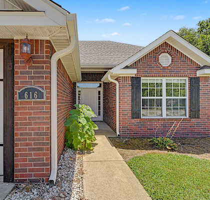 A house with a garage and a sidewalk leading up to the front door.
