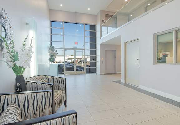 A living room with a zebra print sofa and a glass table at Woodley Sara Apartment, Van Nuys, 91406