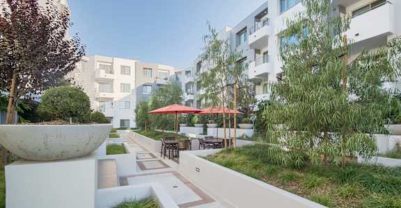 A white concrete pillar sits in the middle of a walkway at Woodley Sara Apartment, Van Nuys, 91406