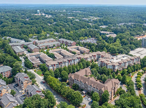 A bird's eye view of a residential area with multiple buildings and greenery. at Westmount at Ashwood Apartments, Georgia