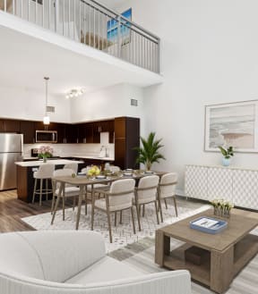 a living room with a dining room table and chairs and a kitchen in the background