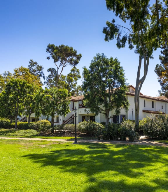 a house with a lawn and trees in front of it at La Jolla Blue, San Diego, California