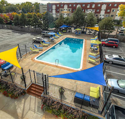 an aerial view of a swimming pool in a parking lot