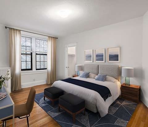 a bedroom with a bed and a desk and a window