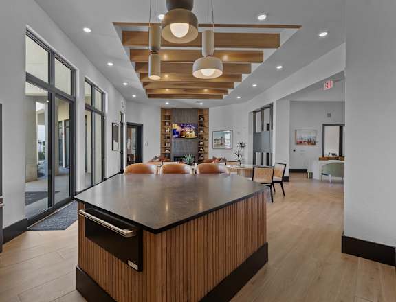 A modern kitchen with a wooden island and stainless steel appliances.