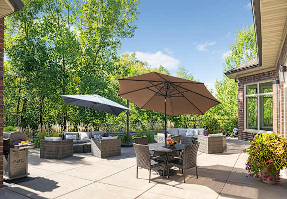 a patio with chairs and umbrellas on a patio