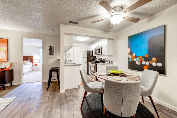 an open living room and kitchen with a table and chairs