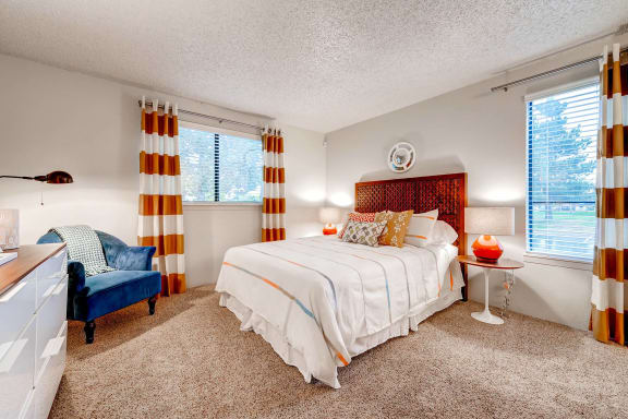 a bedroom with a bed and a chair