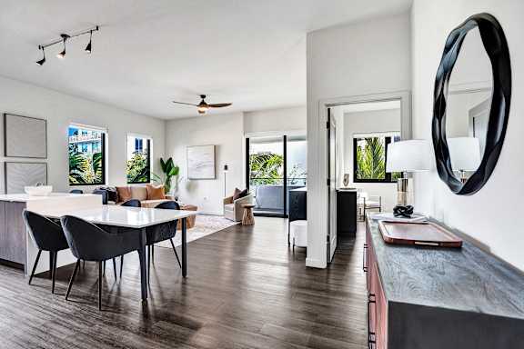 A modern living room with a dining table and chairs.