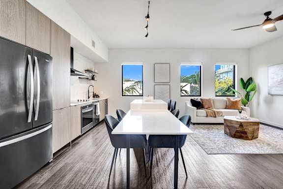A modern kitchen with a dining table and chairs.