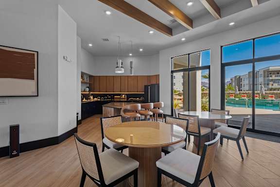 A modern dining room with a large table and chairs.