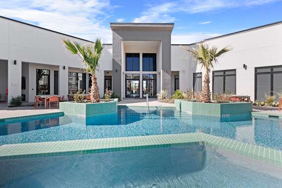 A modern house with a pool in the backyard.
