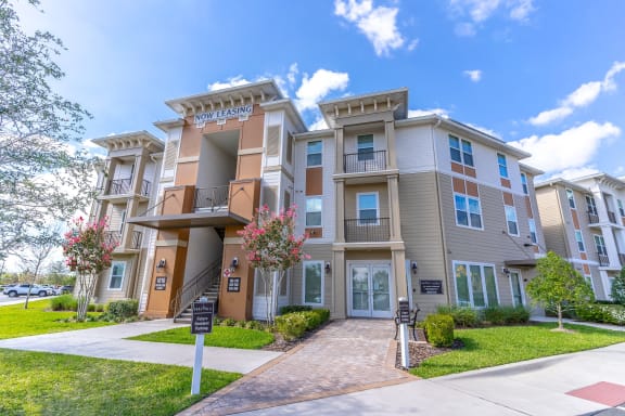 an apartment building with a sidewalk in front of it