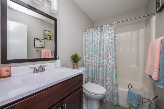 Bathroom with single sink and toilet at St. Croix Apartments in Virginia Beach VA