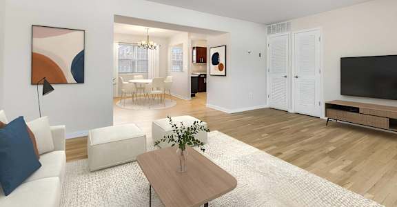 A living room with a white couch, a coffee table, and a painting on the wall. at Chatham Hill, New Jersey, 07928