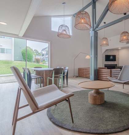 a living room with a table and chairs and a tv at Napa Green Apartments LLC, Napa