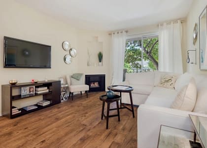 A living room with a fireplace and a television.at Norwalk Metropointe, Norwalk