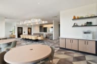 a dining room with a table and chairs