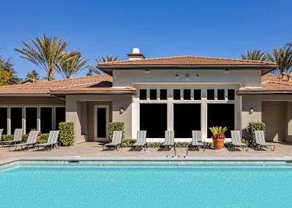 A large house with a pool in front.