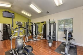 Fitness Center with Ellipticals, Weight Machines and Hardwood Inspired Floors at Monte Bello Apartments, Sacramento, CA