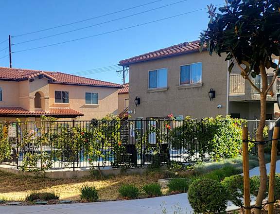 an apartment building with a fence in front of it
