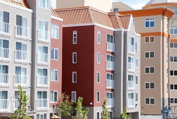 a large apartment building with a red and white facade
