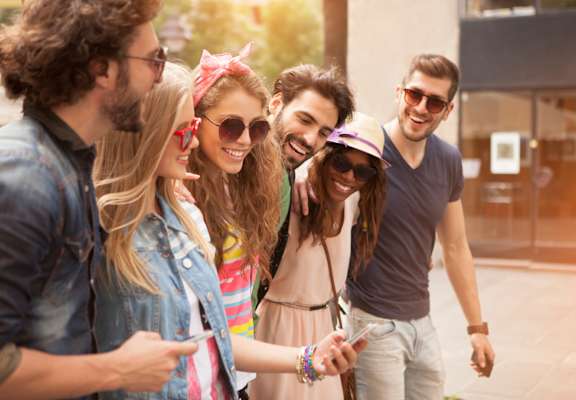 A group of friends are walking down the street together.