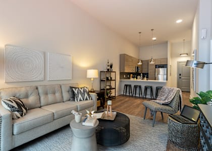 A modern living room with a grey sofa and a coffee table.at Center Square Lofts East, Allentown, PA 18101
