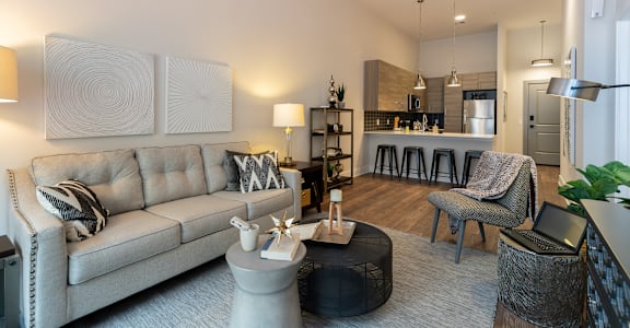A modern living room with a grey sofa and a coffee table.at Center Square Lofts East, Allentown, PA 18101