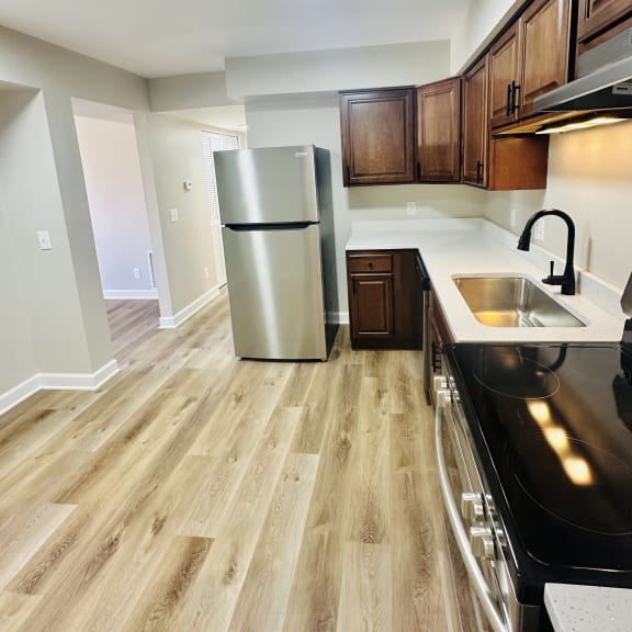 a kitchen with stainless steel appliances and wooden cabinets