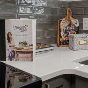 a kitchen with a sink and a book on the counter
