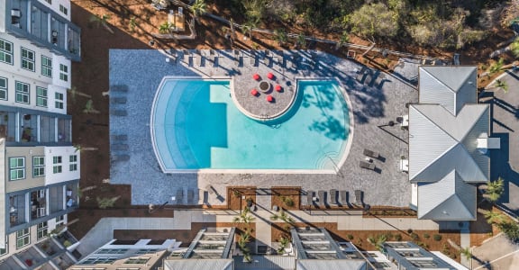 an aerial view of a pool at a hotel with a swimming pool
