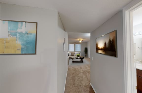 an open living room and hallway with a view of a dining room and living room