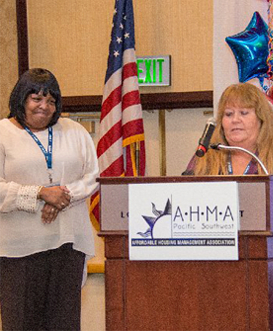 a woman giving a speech at a podium
