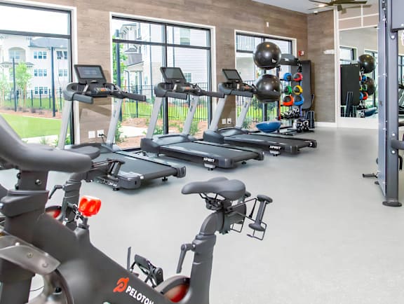 a gym with treadmills and other exercise equipment