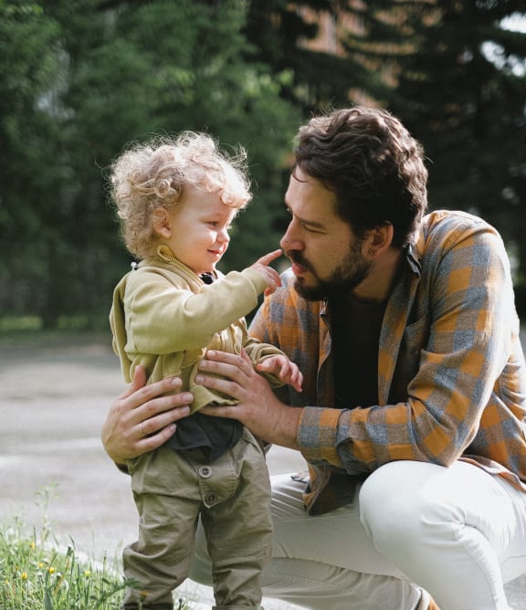 a father and son in a park