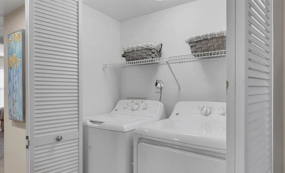 a laundry room with two sinks and a washer and dryer