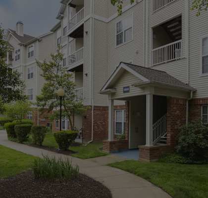 an exterior view of an apartment building with a sidewalk at The Morgan Apartment Homes, Maryland